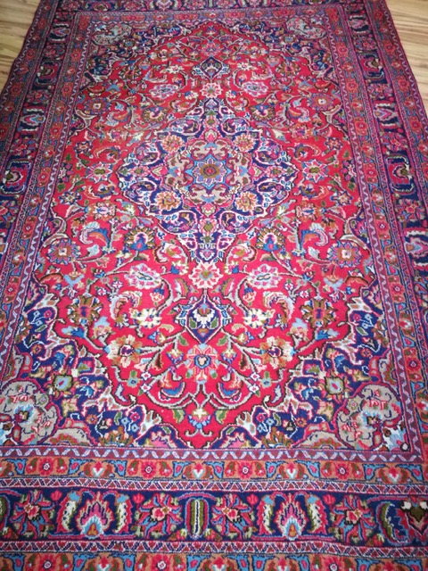 A Tabriz style red and blue ground carpet